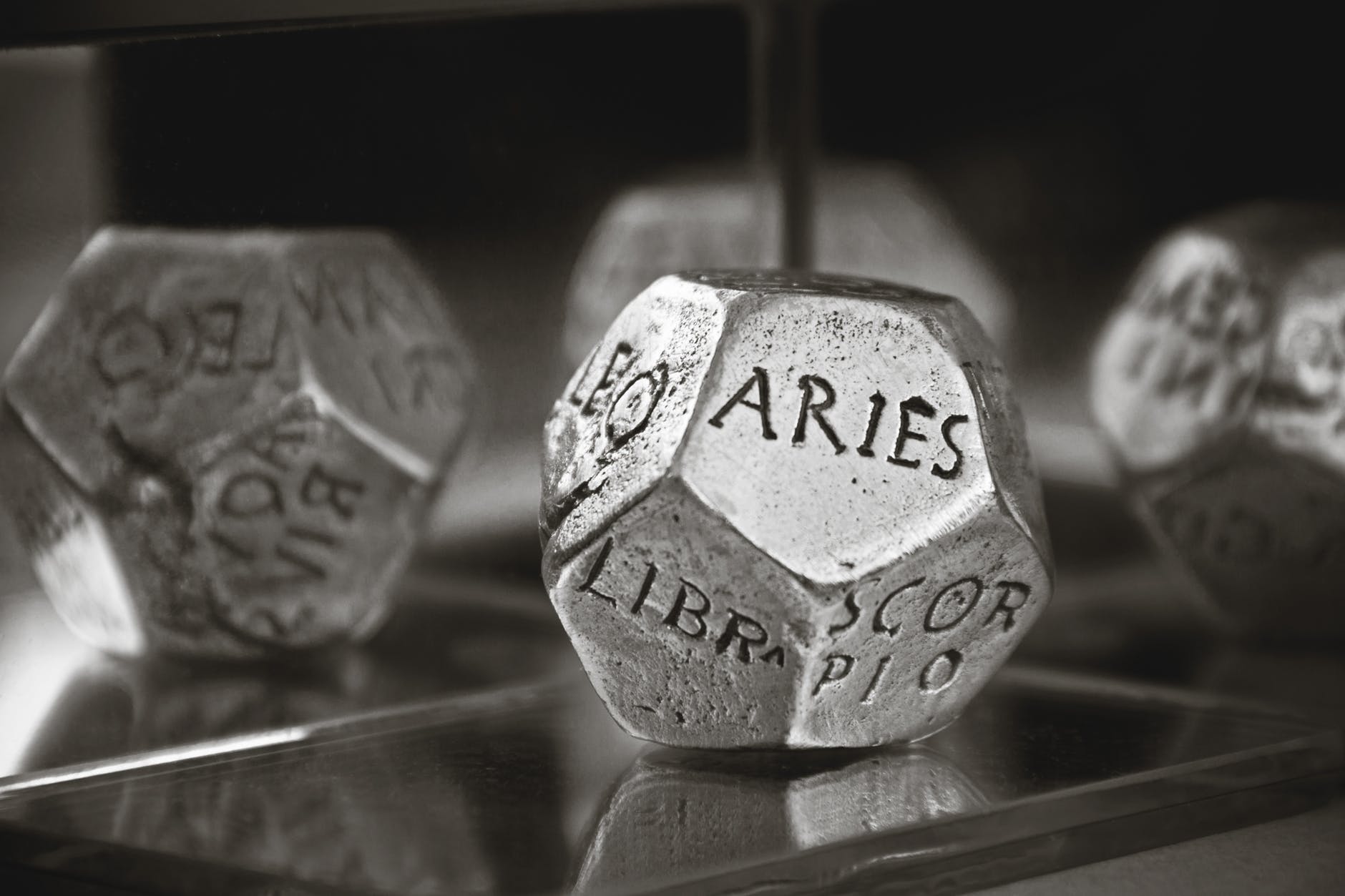 aries dice in gray scale photography